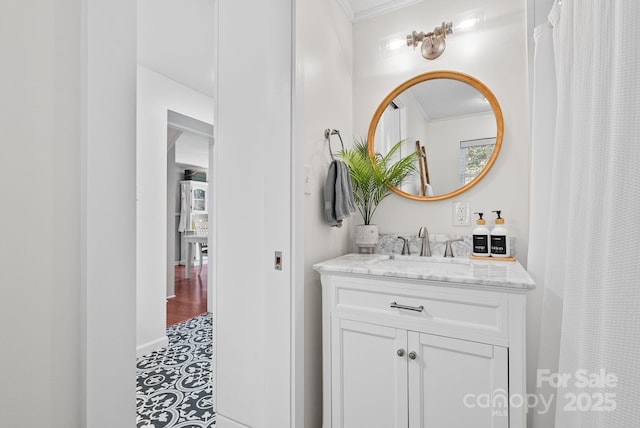 bathroom featuring ornamental molding and vanity