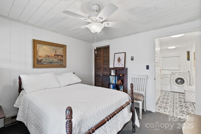 carpeted bedroom with a closet, independent washer and dryer, and ceiling fan