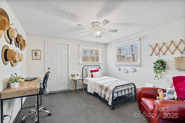 bedroom with carpet, ceiling fan, and a textured ceiling