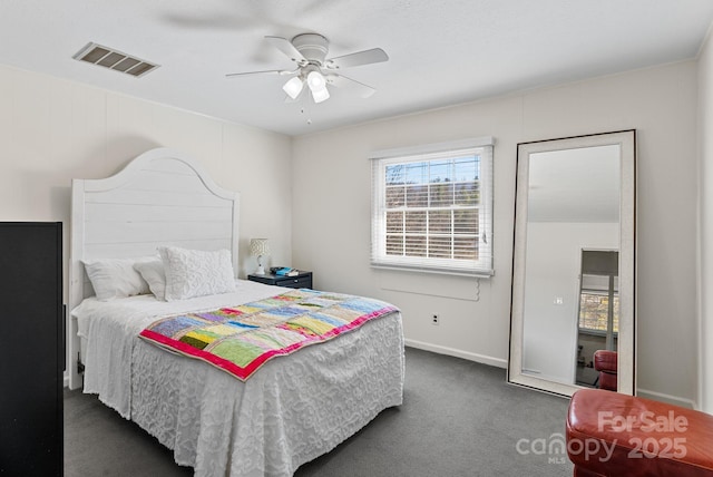 bedroom with dark colored carpet, visible vents, ceiling fan, and baseboards