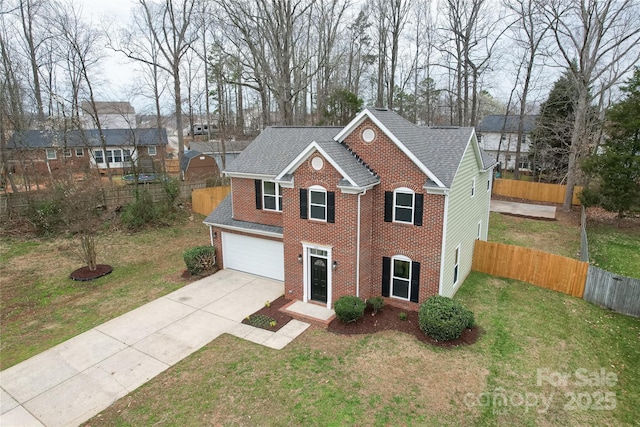 view of front of home featuring a front lawn, fence, brick siding, and driveway