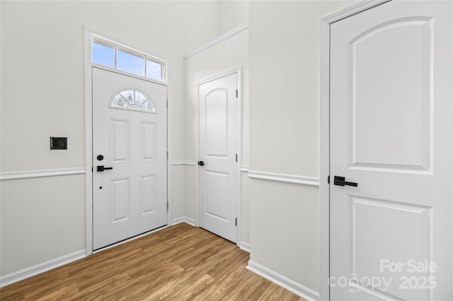 entrance foyer featuring baseboards and wood finished floors