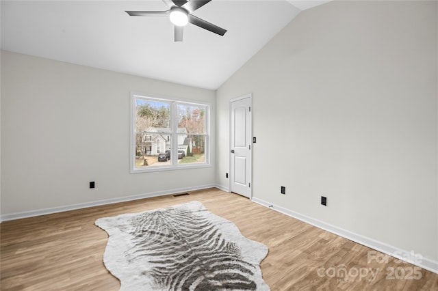 sitting room featuring lofted ceiling, baseboards, visible vents, and light wood-type flooring