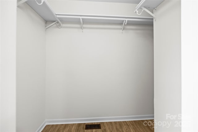 walk in closet featuring visible vents and wood finished floors