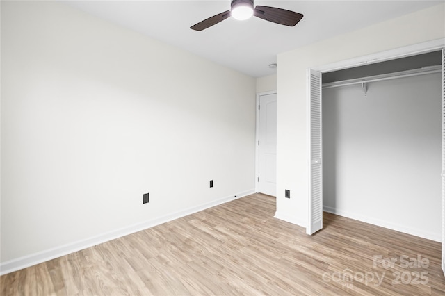 unfurnished bedroom with a closet, baseboards, light wood-style floors, and a ceiling fan