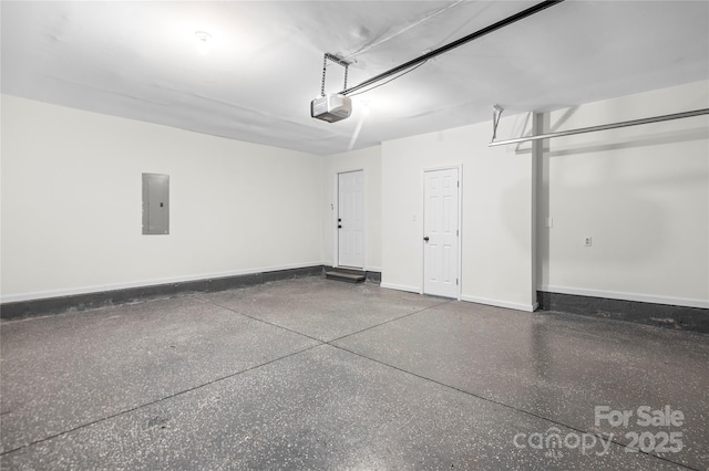 garage featuring electric panel, a garage door opener, and baseboards