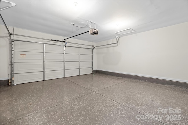 garage featuring a garage door opener and baseboards