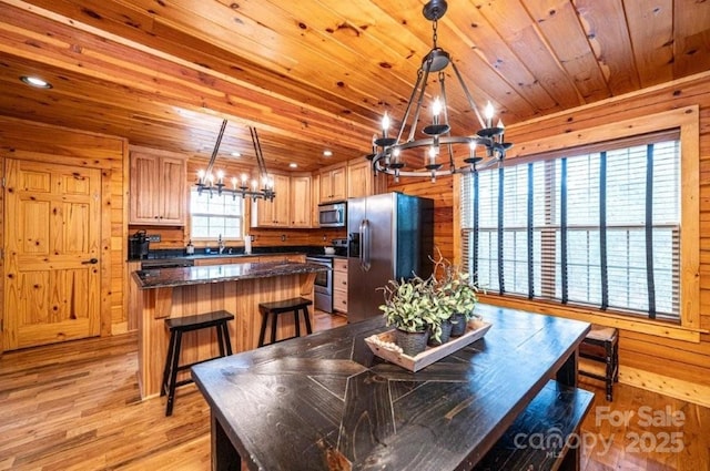 dining space with recessed lighting, wood ceiling, wooden walls, a chandelier, and light wood-type flooring