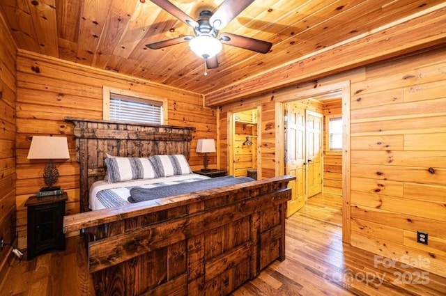 bedroom featuring wooden ceiling, wood walls, and wood finished floors