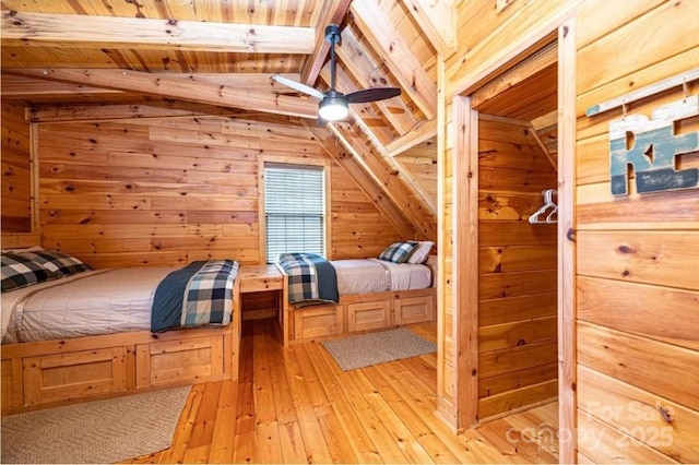 bedroom featuring light wood-style floors, lofted ceiling with beams, a sauna, wooden ceiling, and wood walls