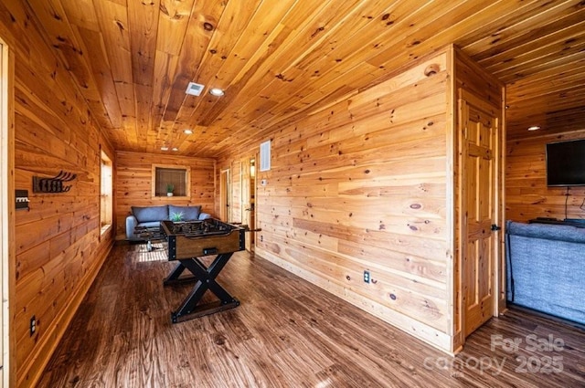 game room with wooden ceiling, recessed lighting, wood finished floors, and wood walls