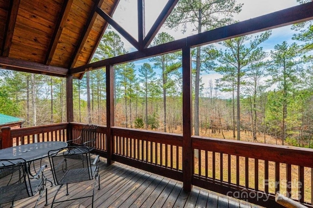 unfurnished sunroom with wood ceiling and vaulted ceiling with beams