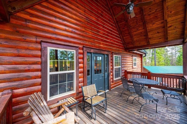 wooden terrace featuring outdoor dining area and a ceiling fan