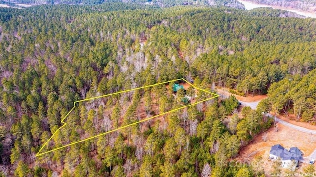 birds eye view of property with a view of trees