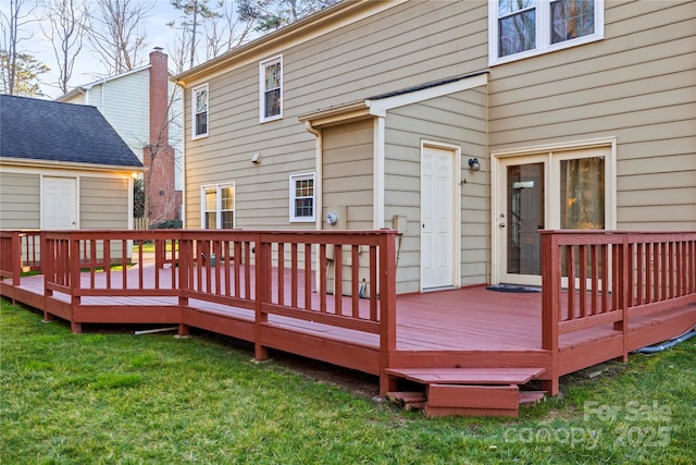 wooden terrace with a lawn