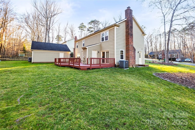 back of house with a lawn, a chimney, fence, a deck, and cooling unit