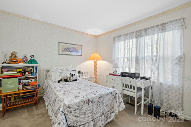 bedroom with carpet, crown molding, and wallpapered walls