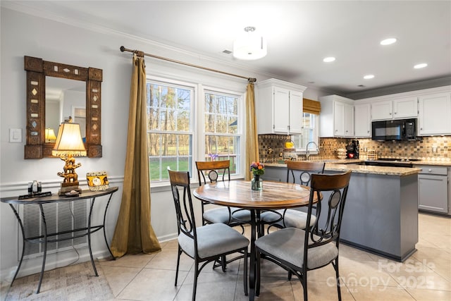 dining room featuring light tile patterned floors, ornamental molding, and recessed lighting