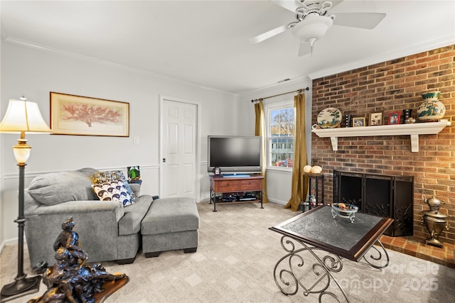 carpeted living room featuring ornamental molding, a fireplace, baseboards, and ceiling fan