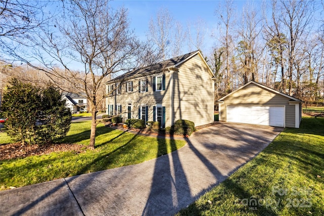 view of front facade with an outdoor structure, a detached garage, and a front lawn