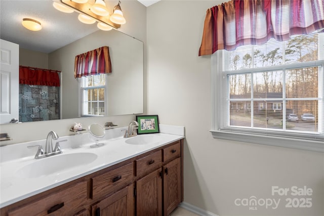 bathroom with double vanity, a textured ceiling, vaulted ceiling, and a sink