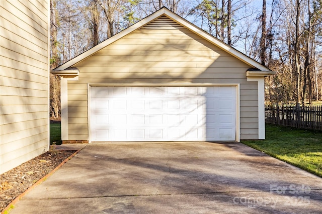 detached garage featuring fence