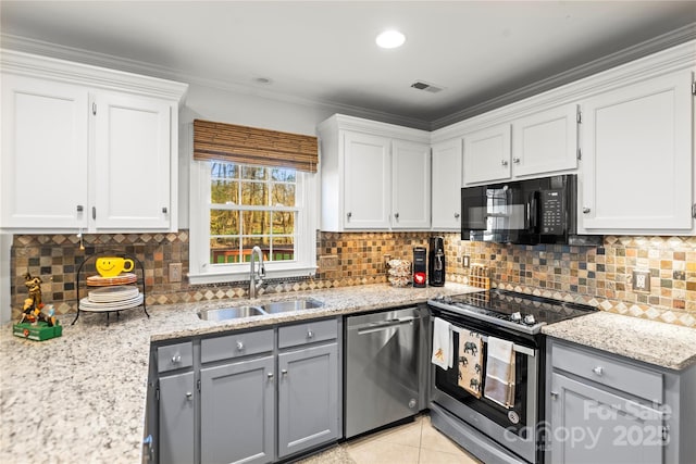 kitchen with light tile patterned floors, visible vents, appliances with stainless steel finishes, gray cabinetry, and a sink