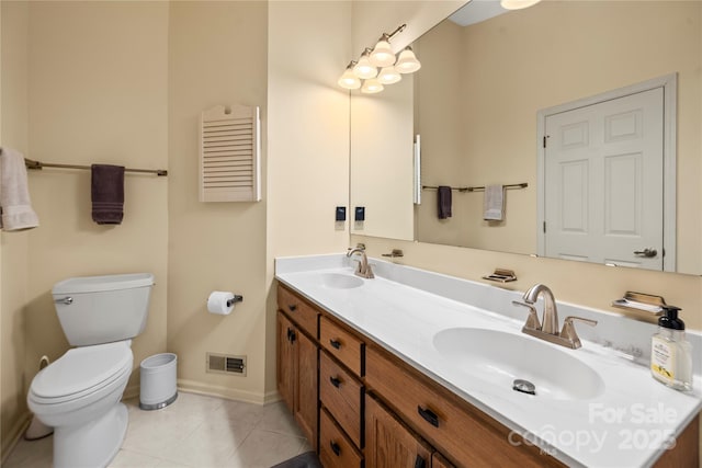 bathroom featuring toilet, a sink, visible vents, and tile patterned floors