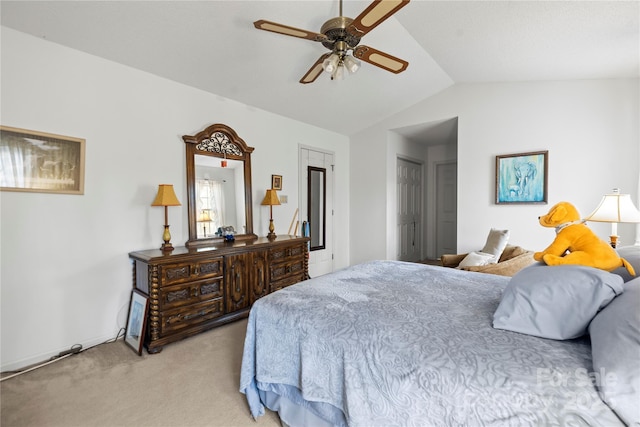 bedroom featuring light carpet, lofted ceiling, and a ceiling fan