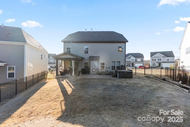 rear view of property featuring a fenced backyard, a residential view, and a patio