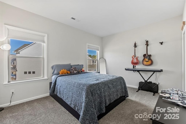 carpeted bedroom featuring visible vents and baseboards