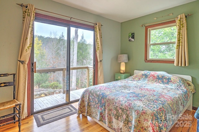 bedroom featuring access to outside and wood finished floors