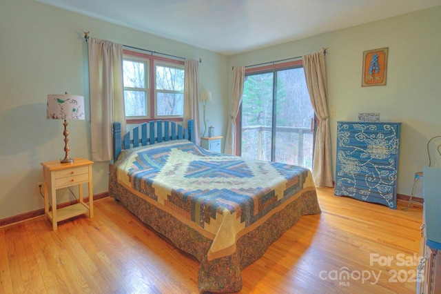 bedroom featuring wood finished floors and baseboards