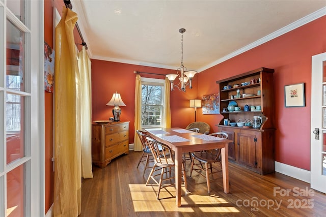 dining room with baseboards, a chandelier, wood finished floors, and ornamental molding