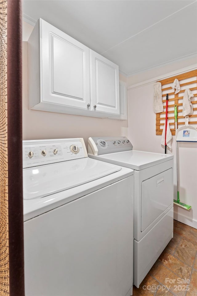 laundry area featuring cabinet space and separate washer and dryer