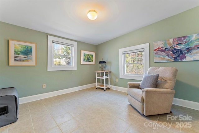 sitting room featuring light tile patterned floors and baseboards