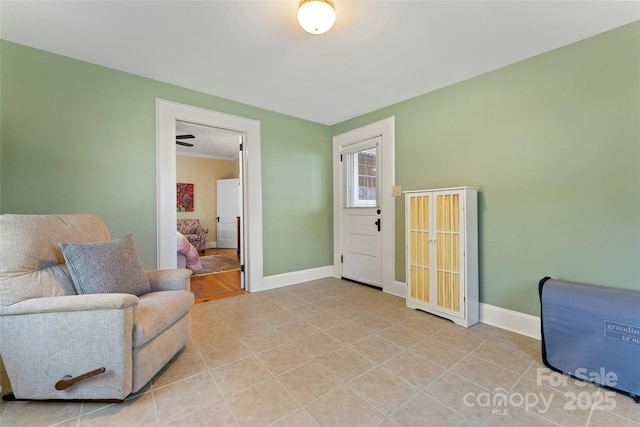 living area with light tile patterned flooring and baseboards