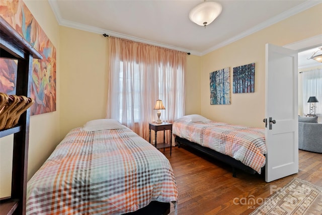 bedroom featuring ornamental molding and wood-type flooring