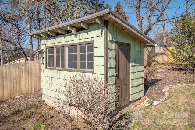 view of outbuilding featuring a fenced backyard and an outbuilding