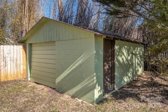 view of outbuilding with fence and an outdoor structure