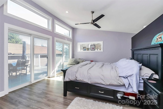 bedroom with lofted ceiling, wood finished floors, a ceiling fan, and access to exterior