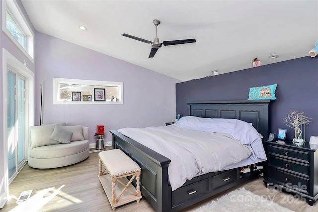 bedroom featuring vaulted ceiling, baseboards, light wood-style flooring, and a ceiling fan