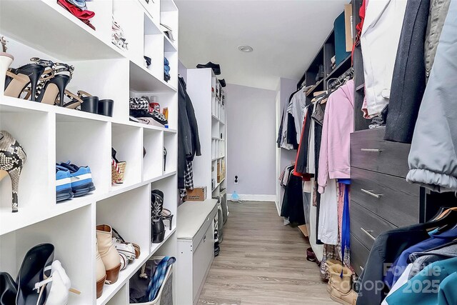 walk in closet featuring light wood-style flooring