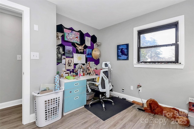 office space featuring baseboards and wood finished floors