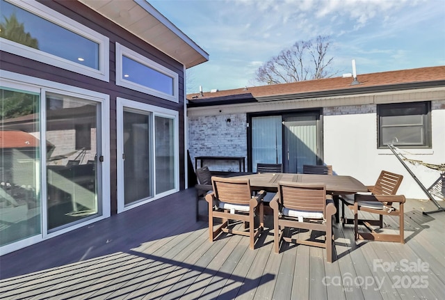 wooden terrace featuring outdoor dining space