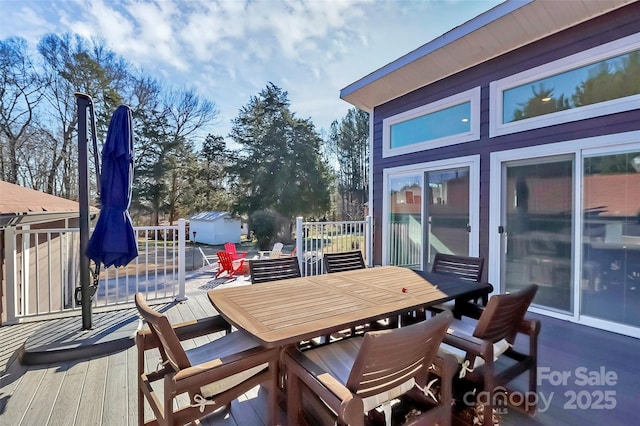 wooden terrace with outdoor dining space