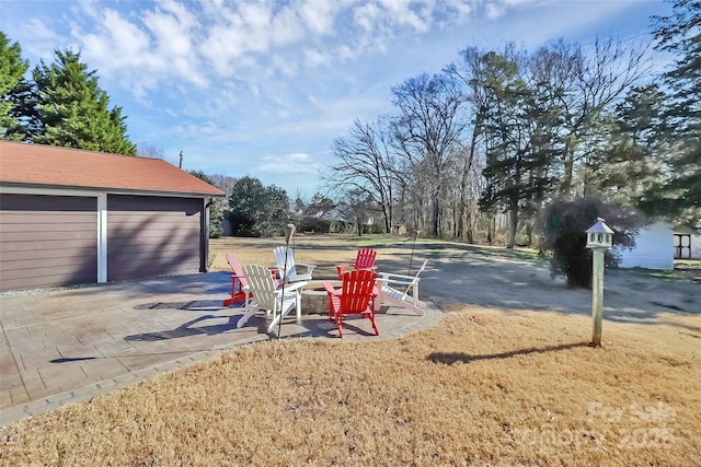 view of yard with a patio area and an outdoor fire pit