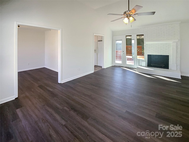 unfurnished living room featuring dark wood-type flooring, a fireplace, a ceiling fan, and baseboards