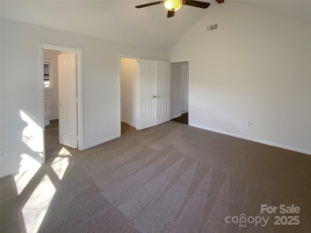 unfurnished bedroom with carpet floors, visible vents, ensuite bath, high vaulted ceiling, and baseboards