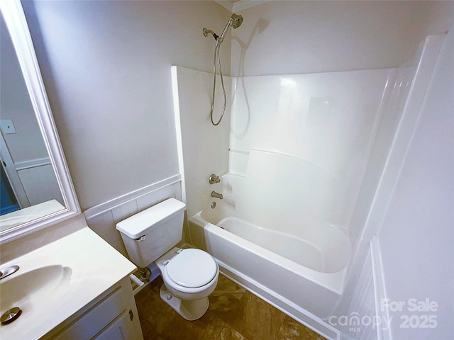 bathroom with toilet, vanity, and shower / bathtub combination